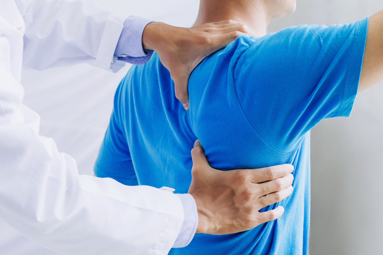 Male doctor therapist working examining treating injured back.Back pain patient, treatment, medical doctor,massage for back pain relief office syndrome."